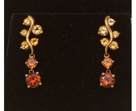 A pair of citrine drop earrings, yellow and orange coloured citrines in a branch pattern drop mount, 9ct. yellow gold.