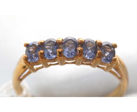 A five-stone Iolite ring, the uniform row of oval facet-cut Iolites on 9ct. yellow gold shank, ring size P, 1.9grms gross.