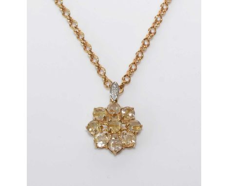 A rutile included quartz pendant, set with nine circular facet-cut quartz stones with needle-like rutile inclusions, hanging 