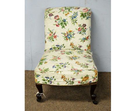 A 20th Century occassional chair, the scroll over padding back and sprung seat raised on squat cabriole legs and floral pleat