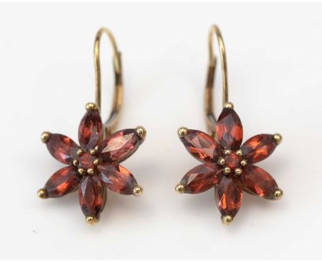 A pair of garnet cluster earrings, each set with a central circular facet-cut garnet surrounded by six marquise-cut garnets, 
