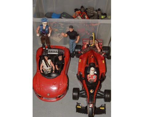 Two Action Man red model sports cars, 65 cms long, along with a collection of Action Man figures and accessories.