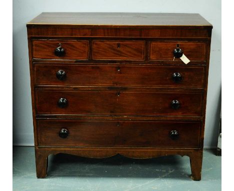 A Regency mahogany chest of drawers, the caddy top above an arrangement of three short drawers and three long graduated drawe