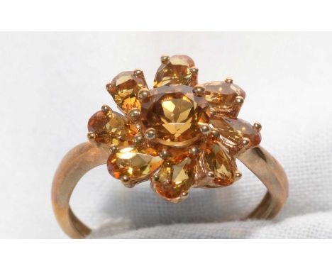 A citrine cluster ring, the circular facet-cut central citrine surrounded by eight pear-cut citrines, on 9ct. yellow gold sha