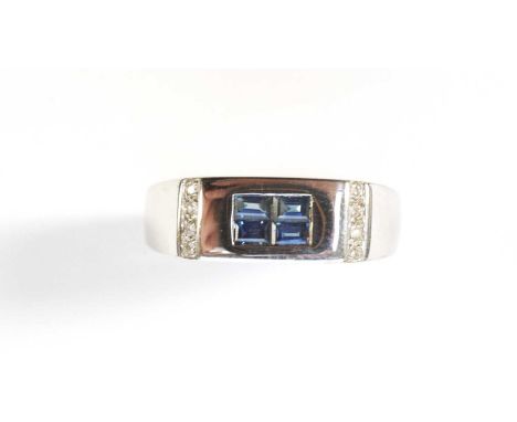 A sapphire and diamond ring, the four rectangular step-cut sapphire set to plaque flanked by eight-cut diamonds, on 9ct white