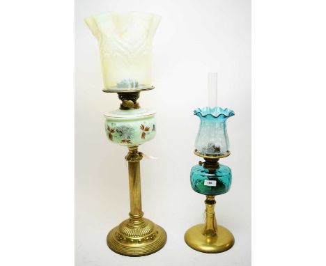 An early 20th Century Column formed oil lamp, with painted glass reservoir and opal coloured shape; another later oil lamp (2