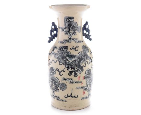 A 19th Century Chinese ovoid vase with trumpet neck, decorated in dark underglaze blue and white with Buddhist lions and clou