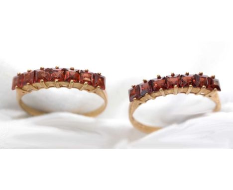 Two garnet rings, each set with seven square step-cut garnets, on 9ct. yellow gold shank, ring size P, 3.2grms gross.