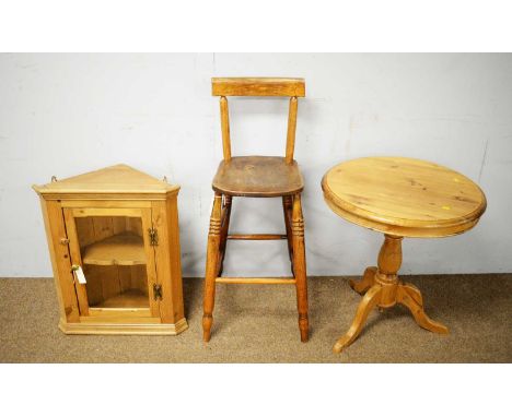 A 20th Century pine top table, the circular top on central baluster turned column raised on a tripartite base with pad feet, 