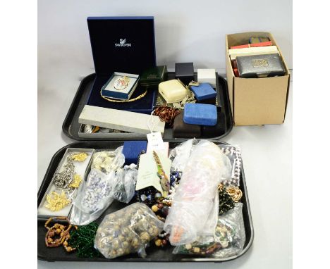 A selection of costume jewellery on two trays, including mostly Necklaces and Brooches; a doll and, playing card etc