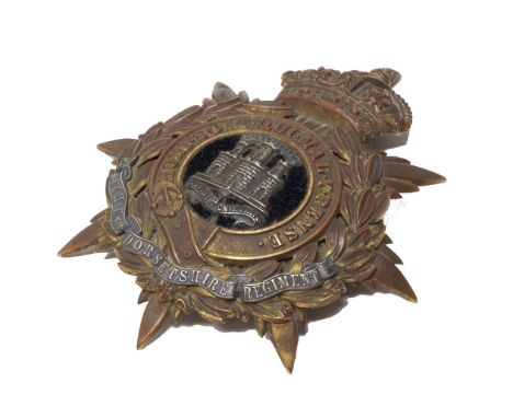 An infantry officer's blue cloth helmet plate, post 1902, King's crown, detailed The Dorsetshire Regiment (the original gildi