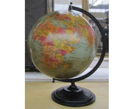 A terrestrial globe, c.1970, mounted on an ebonised turned wooden base, the globe 28cm diameter, 42cm high.