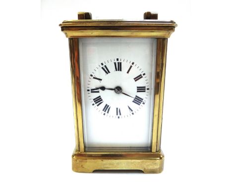 A brass cased carriage clock, early 20th century, with white enamel dial and two train movement, 12cm high.