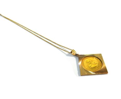 A South Africa gold one rand coin 1974, in a gold pendant mount, with a gold neckchain, detailed 9 K.