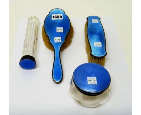 Four silver and blue enamel mounted lady's toilet wares, comprising; a lidded glass jar, Birmingham 1926, a tall glass jar, B