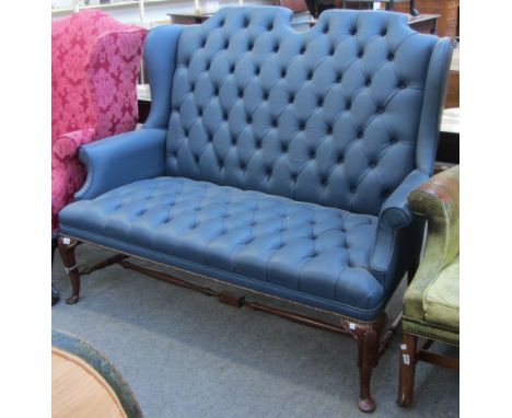 A Queen Anne design blue leather upholstered button backed sofa on walnut cabriole supports, 152cm wide.