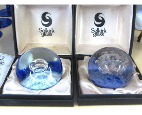 A group of eight glass paperweights, comprising; two Selkirk glass limited edition weights by Peter Holmes, `Nebula' and `Atl