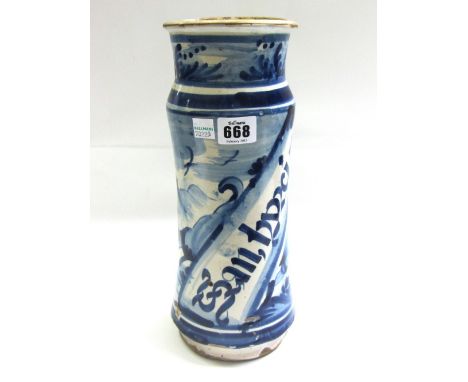 A Spanish faience blue and white albarello , probably 18th century, painted in blue with a figure against a landscape with of