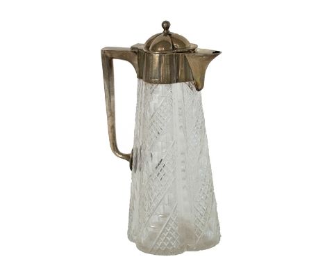 A silver mounted faceted glass claret jug, of tapering quatrefoil shaped form, with an angular handle, the hinged lid with a 