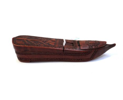A fruitwood carved novelty shoe snuff box, 19th century, probably Scandinavian, the top with two hinged lids carved with a na