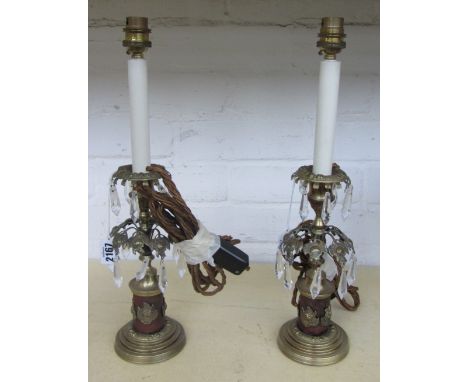 A pair of gilt metal table lamps, modern, each modelled, as Regency candlestick lustres (37cm high) and a leather fire bucket