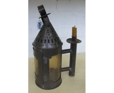An unusual tin lantern or night light, 19th century, of pierced metal construction, the circular body with sheet horn apertur