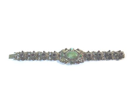 A garnet, turquoise and gem set bracelet, the front in a panel shaped design, mounted with turquoise, the other links mounted