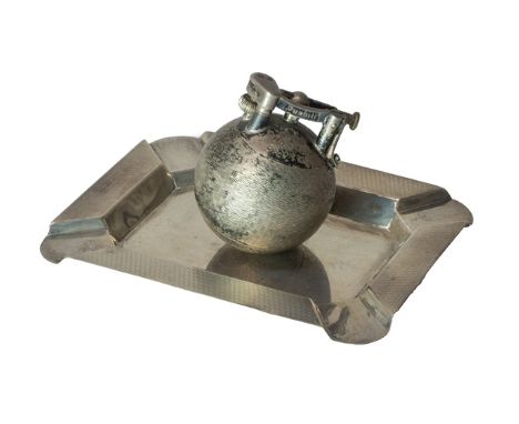 A Dunhill silver spherical petrol lighter, with engine turned decoration, presentation inscribed, the hinged curved top arm d