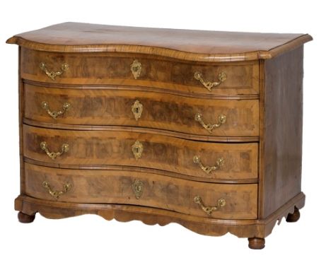 An 18th century North European figured walnut four drawer commode on bun feet, 127cm wide.  Illustrated
