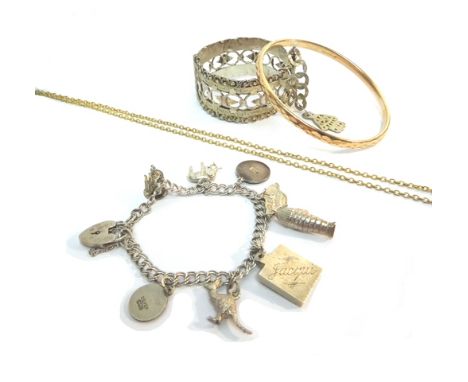 Jewellery, comprising; a silver charm bracelet, an enameled Egyptian mummy case charm, containing the mummy, four enameled sh