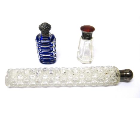 A Victorian blue overlaid, faceted mirrored glass, hinge lidded scent bottle, a Victorian silver mounted, faceted glass, long