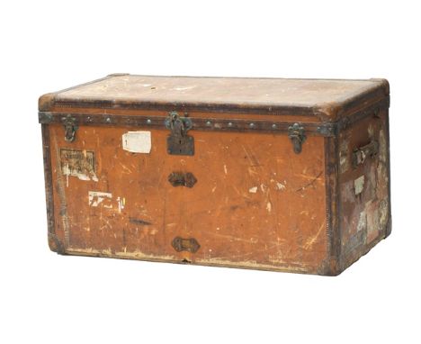 A Louis Vuitton cabin trunk, early 20th century, with brown canvas body and brass hardware, leather handles, with castors to 