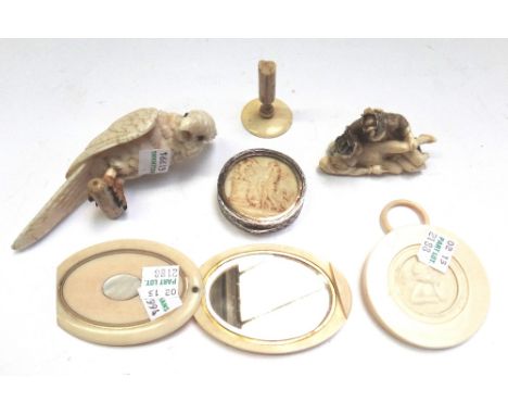 A Victorian carved ivory parrot, 12cm, an ivory and inlaid compact of oval form, a turned ivory circular brooch relief carved