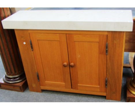 A 20th century light oak two door side cabinet with Portland stone top, 117cm wide. 