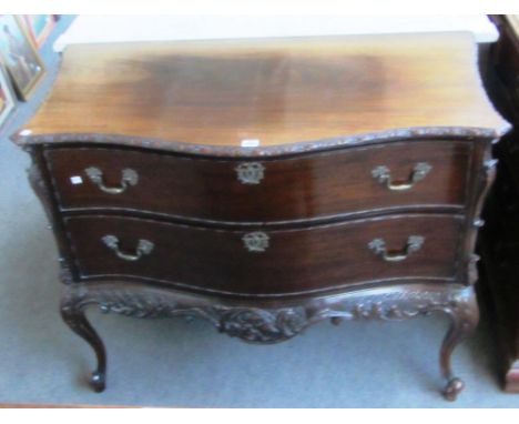 An 18th century style continental mahogany serpentine two drawer commode on cabriole supports, 111cm wide. 