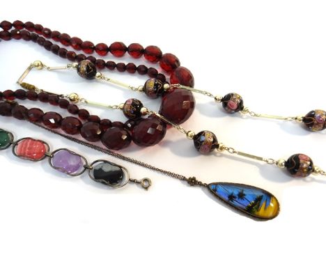 A single row necklace of graduated, treated reconstituted translucent amber beads, a gilt metal necklace, spaced with coloure