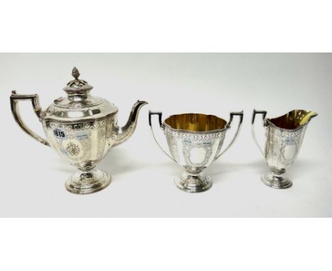 A Victorian plated three piece tea set, comprising; a teapot, a twin handled sugar bowl and a milk jug, each piece of urn sha