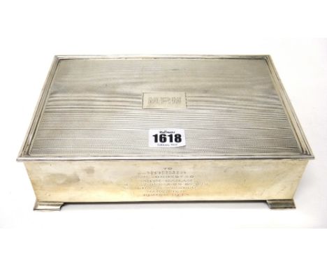 A silver rectangular hinge lidded table cigar box, (most of the interior wooden lining missing), the lid engine turned and in