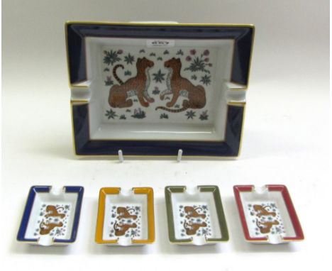 A Hermes porcelain ashtray decorated with two leopards within a cobalt blue and gilt border, gilt lettered HERMES PARIS and f