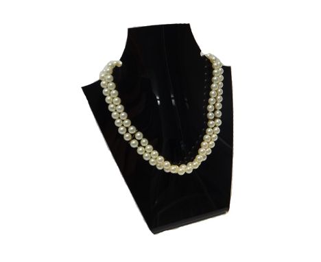 A two row necklace of uniform cultured pearls, on a gold, sapphire and cultured pearl set circular clasp, mounted with the si
