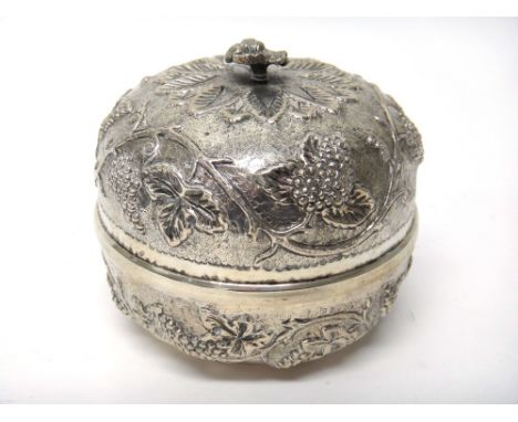 An Eastern circular bowl and cover, the body decorated with fruiting vine and with a flower finial to the cover and an Easter