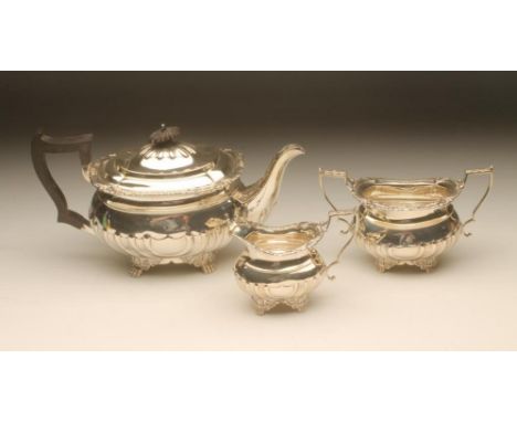 A LATE VICTORIAN THREE PIECE SILVER TEA SERVICE, maker Turner Bradbury, London 1899, of semi-fluted oblong baluster form rais