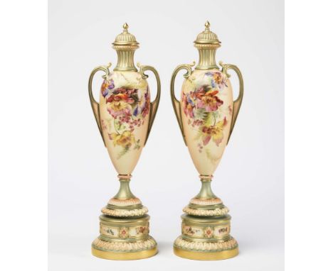 A PAIR OF ROYAL WORCESTER CHINA BLUSH IVORY VASES AND COVERS, 1899, of slender rounded conical form with waisted fluted necks