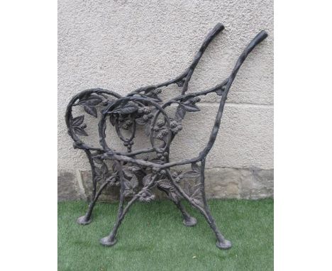 A PAIR OF VICTORIAN CAST IRON BENCH ENDS pierced and moulded with a fruiting bramble, the splayed legs with pad feet, 18" x 3