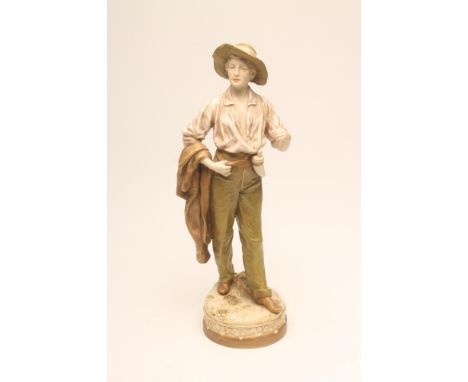 A ROYAL DUX BISQUE PORCELAIN FIGURE, early 20th century, modelled by F. Otto as a young man wearing a wide brimmed hat, open 