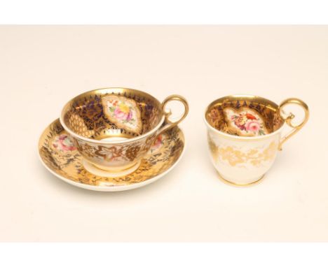 A SPODE PORCELAIN TRIO, c.1820, with high ring handles, painted in polychrome enamels with flowers on a gilt highlighted blue