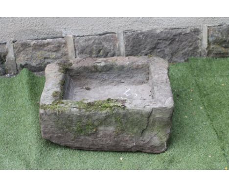 A SANDSTONE TROUGH of rough hewn oblong form, 23 1/2" x 18 1/2" x 9" (Est. plus 21% premium inc. VAT)