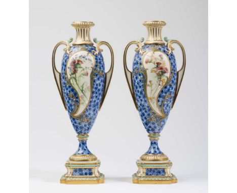 A PAIR OF LATE VICTORIAN ROYAL WORCESTER CHINA VASES of slender ovoid form with acanthus leaf sheathed bi-furcated loop handl