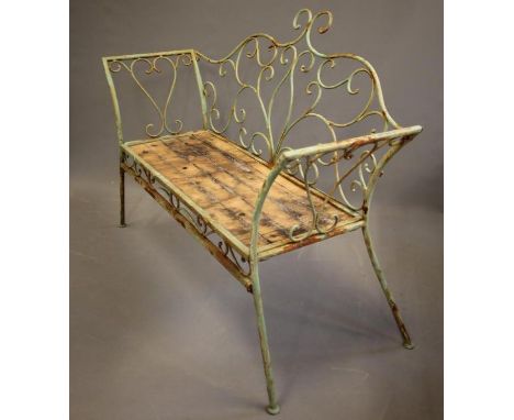 A TUBULAR METAL GARDEN BENCH, c.1900, possibly French, with arched open scroll work back, similar splayed sides, solid seat a