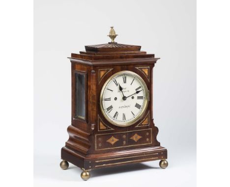 A REGENCY MAHOGANY AND BRASS INLAID BRACKET CLOCK with a bell striking double chain and barrel fusee movement, 6" white ename